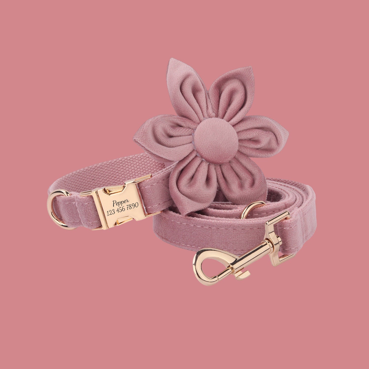 a pink dog leash with a flower on it