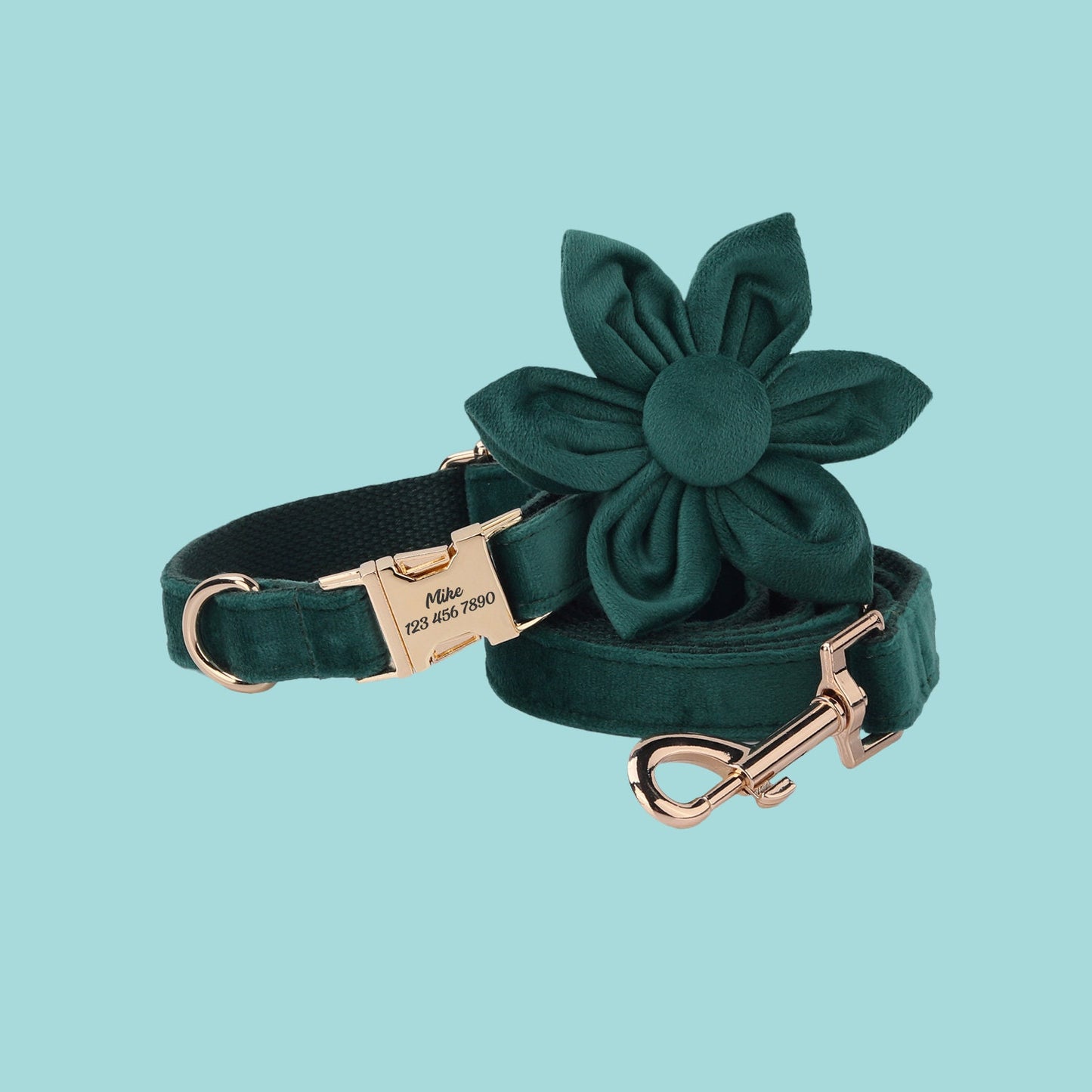 a green dog leash with a flower on it