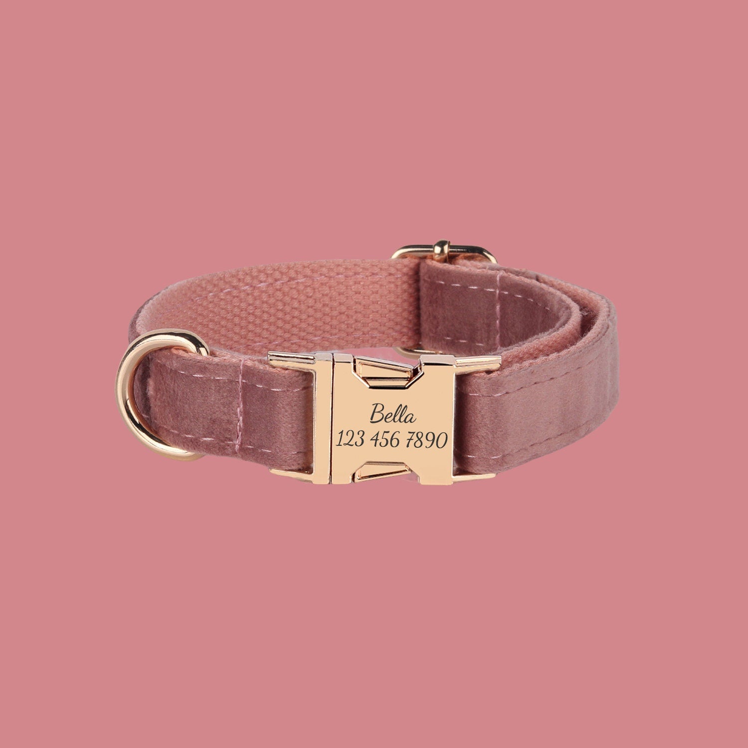 a pink collar with a gold buckle on a pink background