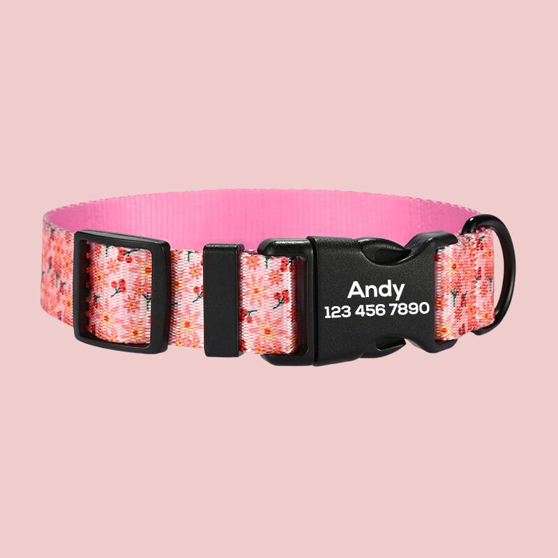 a pink and black dog collar with flowers on it