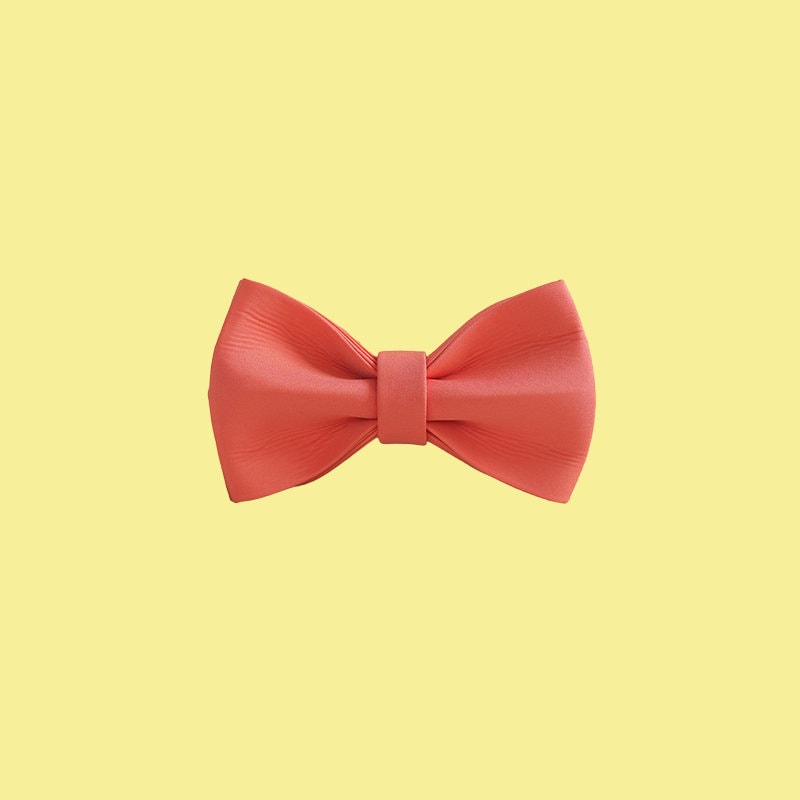 a red bow tie on a white wall